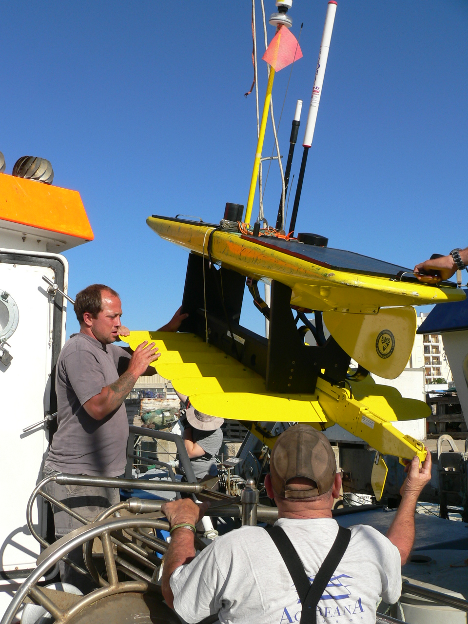 In getting ready to (finally) fly the UAVs from the Diplodus, space is made on the deck by removing the WaveGlider by the crew. The WG also had to have its electronics box replaced, so having it on shore was critical. The UAV team was excited in finally getting to sea...!