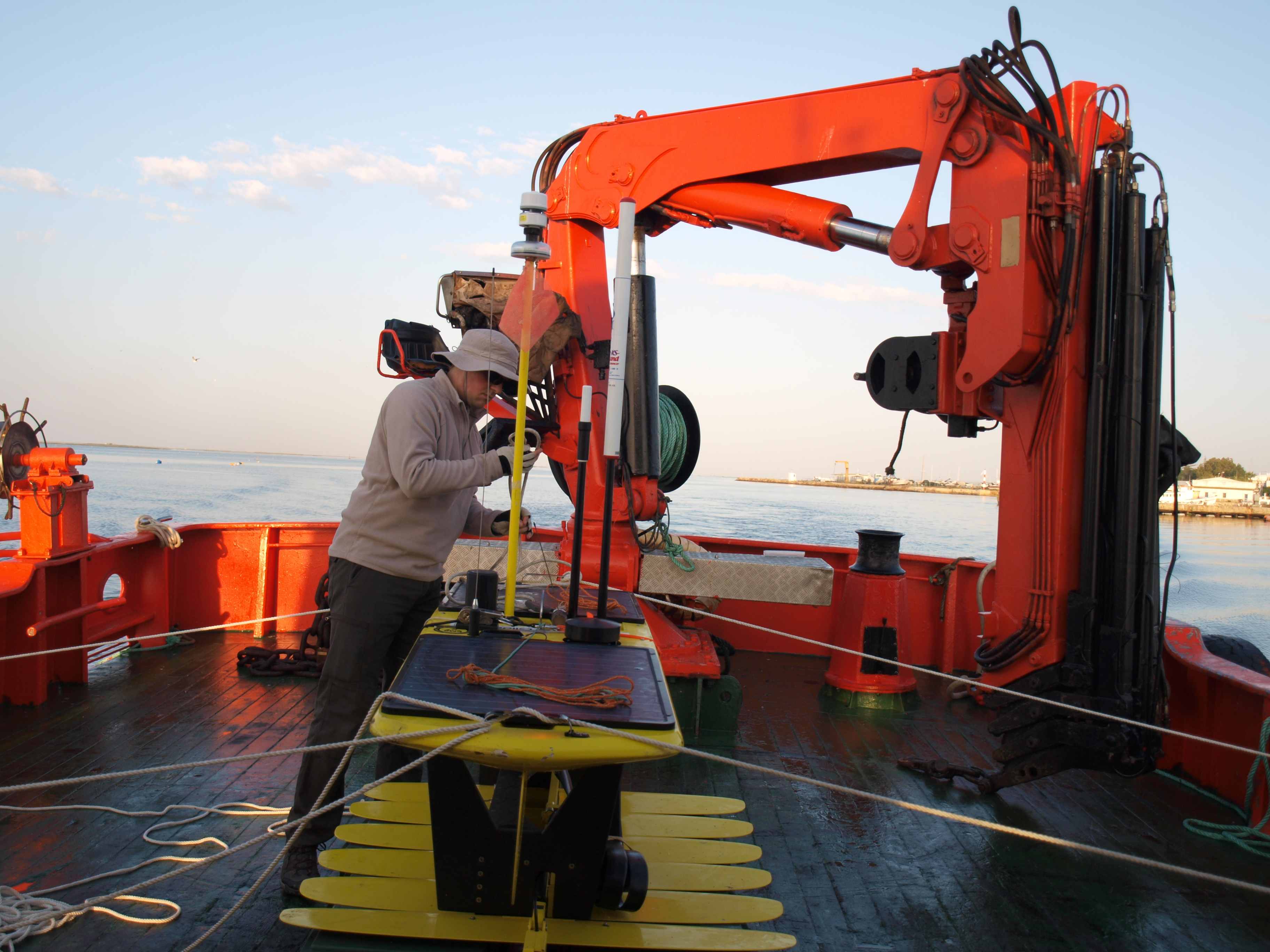Artur on the deck of Cobecho Primero with the WaveGlider Hermes heading out of the Olhão channel.
