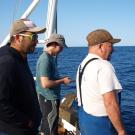 Crew from the Diplodus curious while Renato Caldas commands the  AUV with an Android smartphone