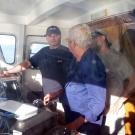 João Tasso and Zé Pinto brief the captain about the day's goals as he pilots the Diplodus from the Olhão estuary.